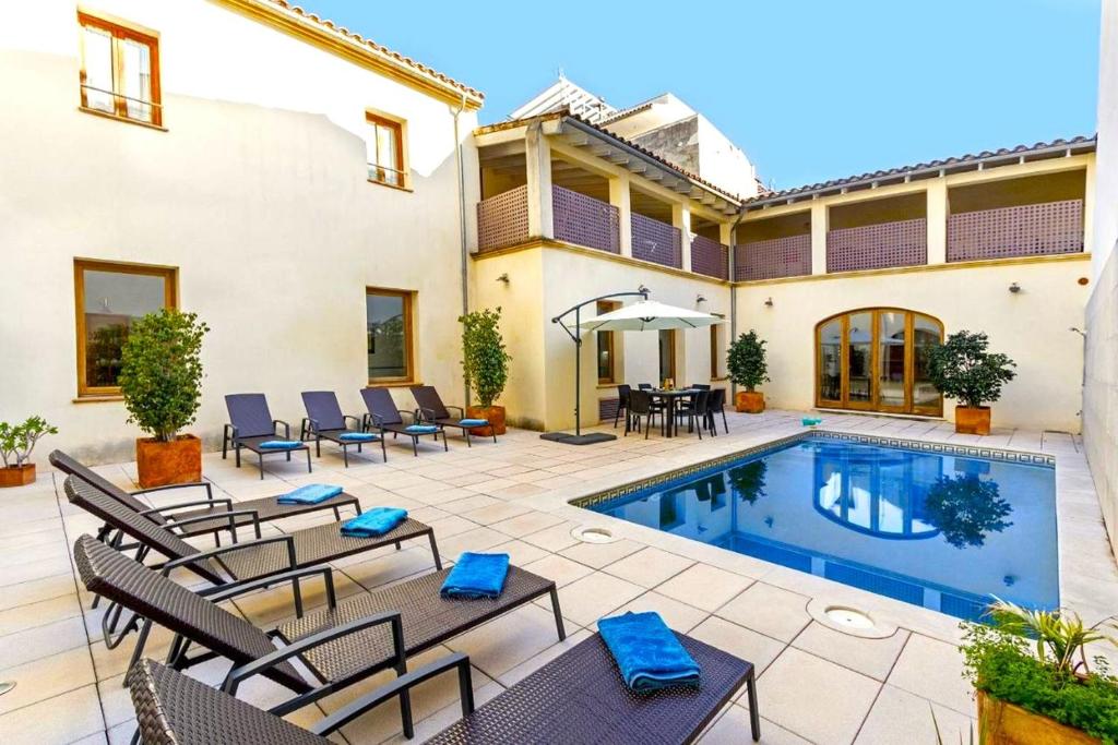a patio with chairs and a swimming pool at Sa Marilyn - Can Campins in Sa Pobla