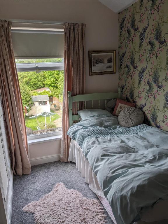 a bed in a bedroom with a window at 6 Trinity grove Ella street HU5 3BB in Hull