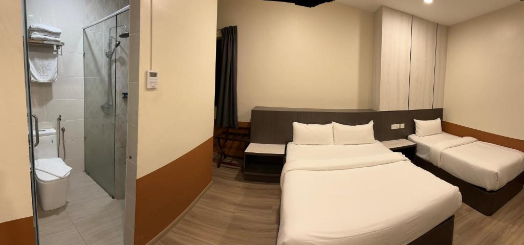 Postel nebo postele na pokoji v ubytování T SQUARE HOTEL (IPOH)