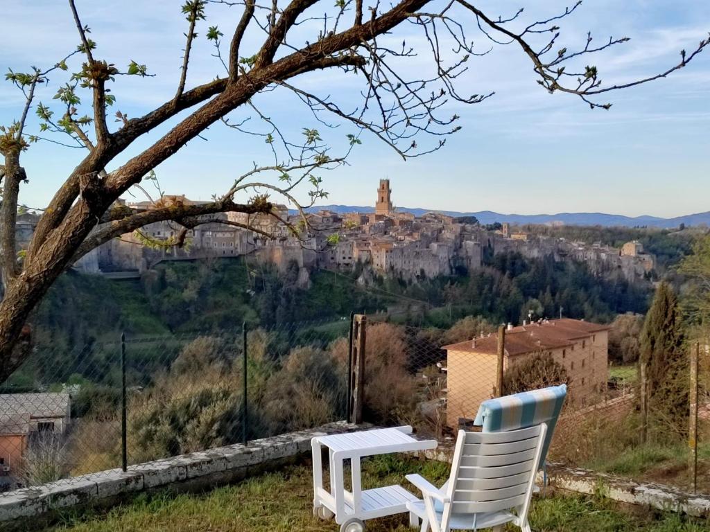 two chairs and a table with a view of a castle at IL NIDO DEL FALCO in Pitigliano