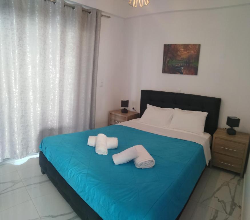 a bedroom with a bed with two towels on it at Ocean view apartment in Ratzaklíon