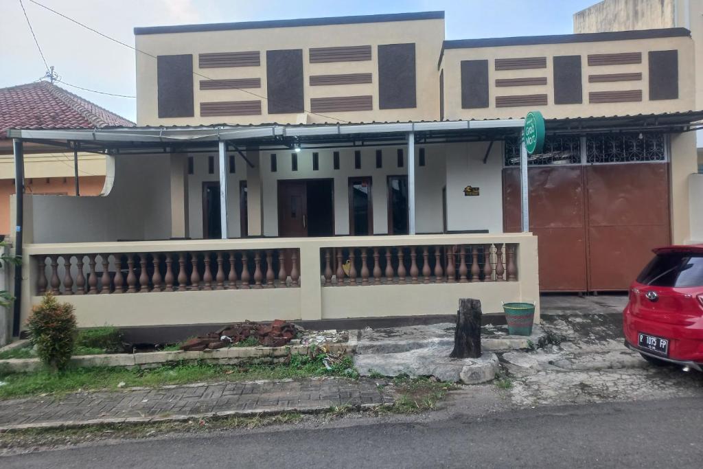 a house with a car parked in front of it at SPOT ON 93917 Homestay Adreena Syariah in Purwokerto