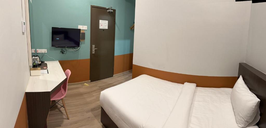 Postel nebo postele na pokoji v ubytování T SQUARE HOTEL (IPOH)