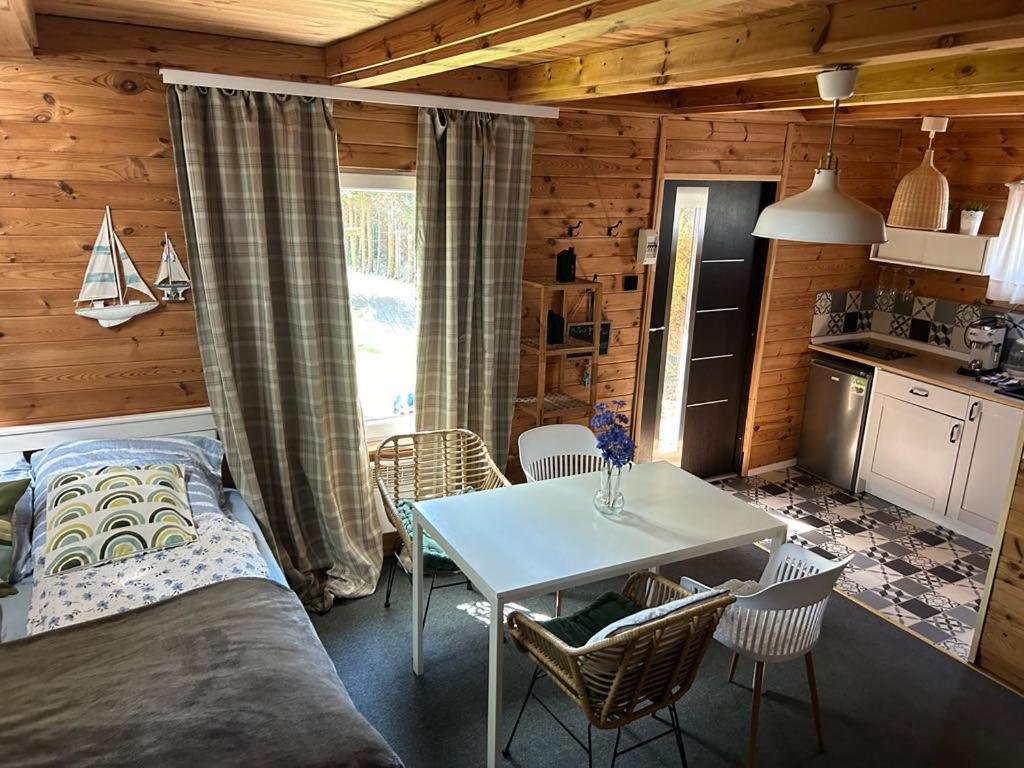 a room with a bed and a table and a kitchen at Ustka- domek nad morzem Marta in Ustka