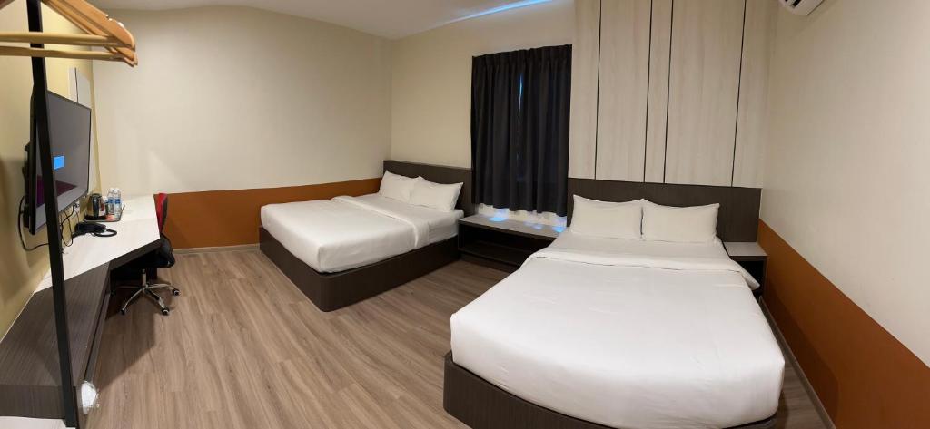 Postel nebo postele na pokoji v ubytování T SQUARE HOTEL (IPOH)