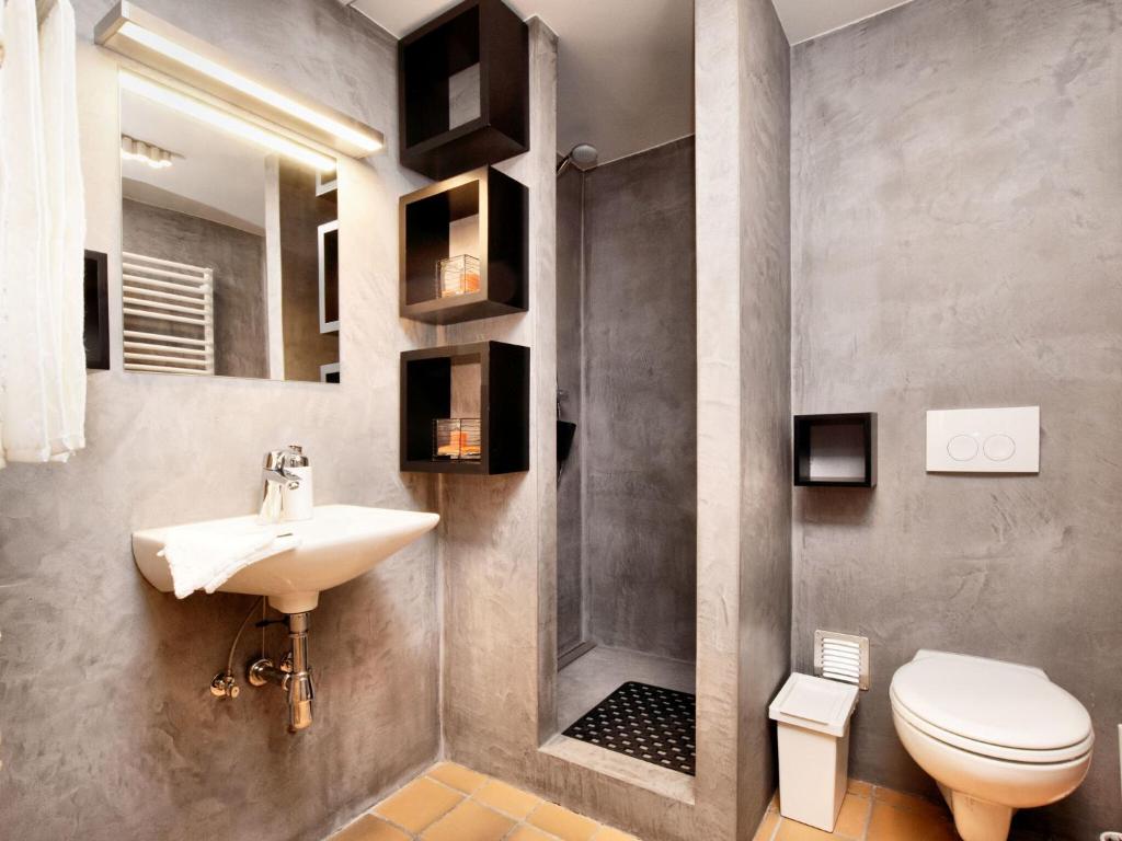 a bathroom with a sink and a toilet at Fancy Holiday Home in Sainte C cile with Pool House Indoor Pool in Sainte-Cécile