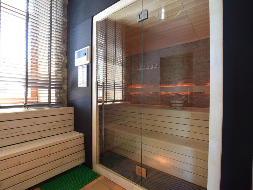 a shower with a glass door in a room at Fancy Holiday Home in Sainte C cile with Pool House Indoor Pool in Sainte-Cécile
