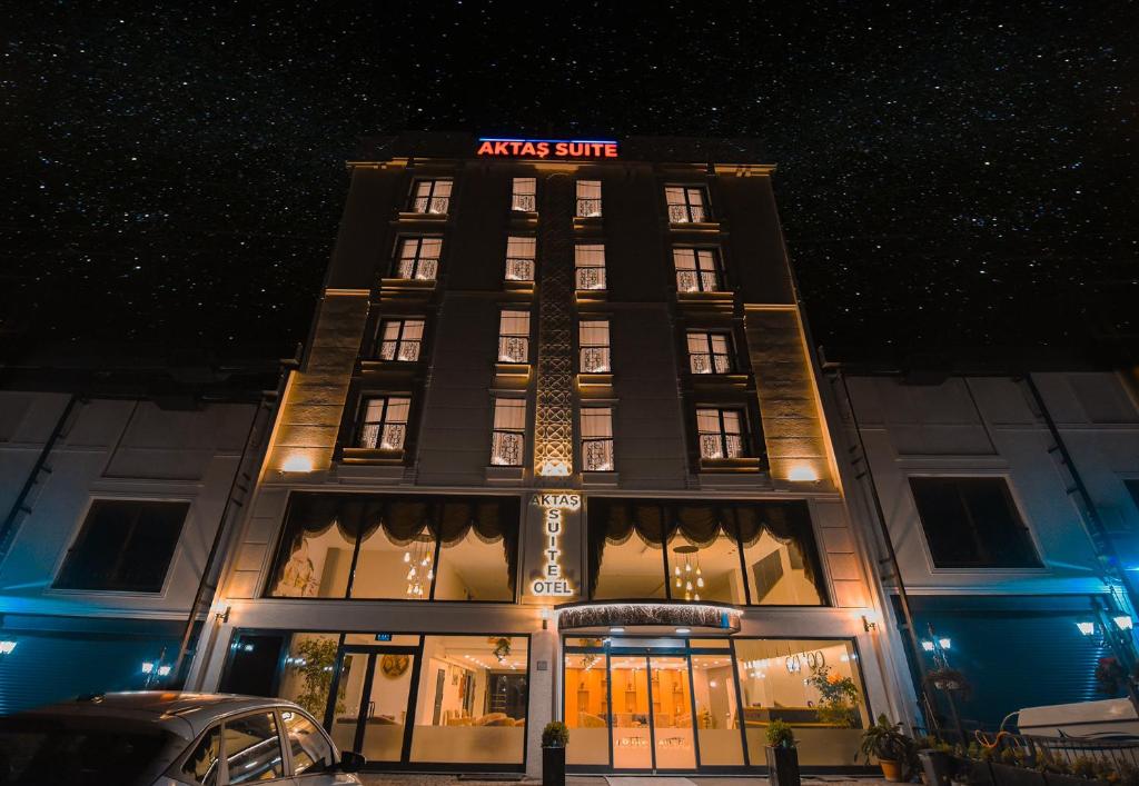a building with a sign on top of it at night at Aktaş Lights Hotel in Trabzon