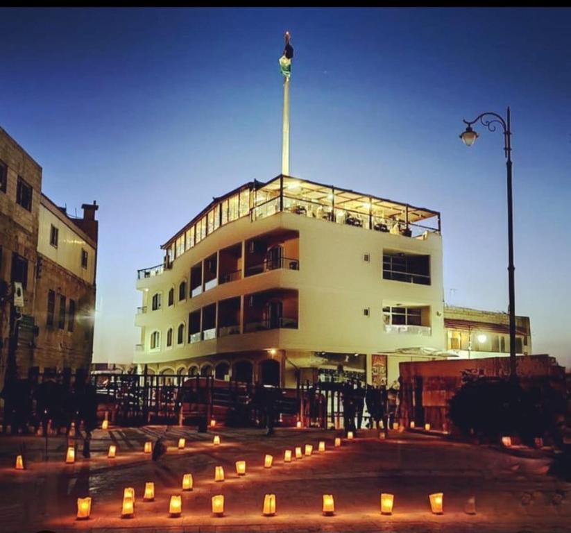 a building with candles in front of it at Saint John Hotel in Madaba