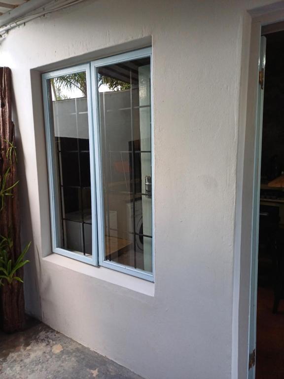 a window on the side of a house at Travelers Nest in St Lucia