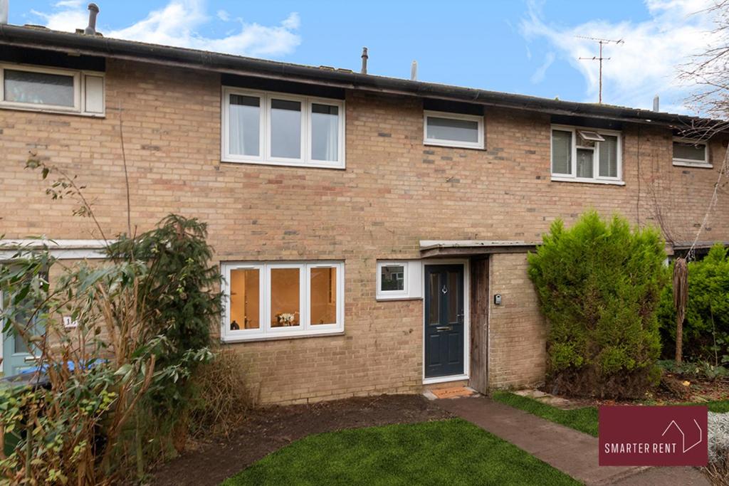 a brick house with a door and a yard at Woking - 3 Bedroom House - With Garden in Chobham