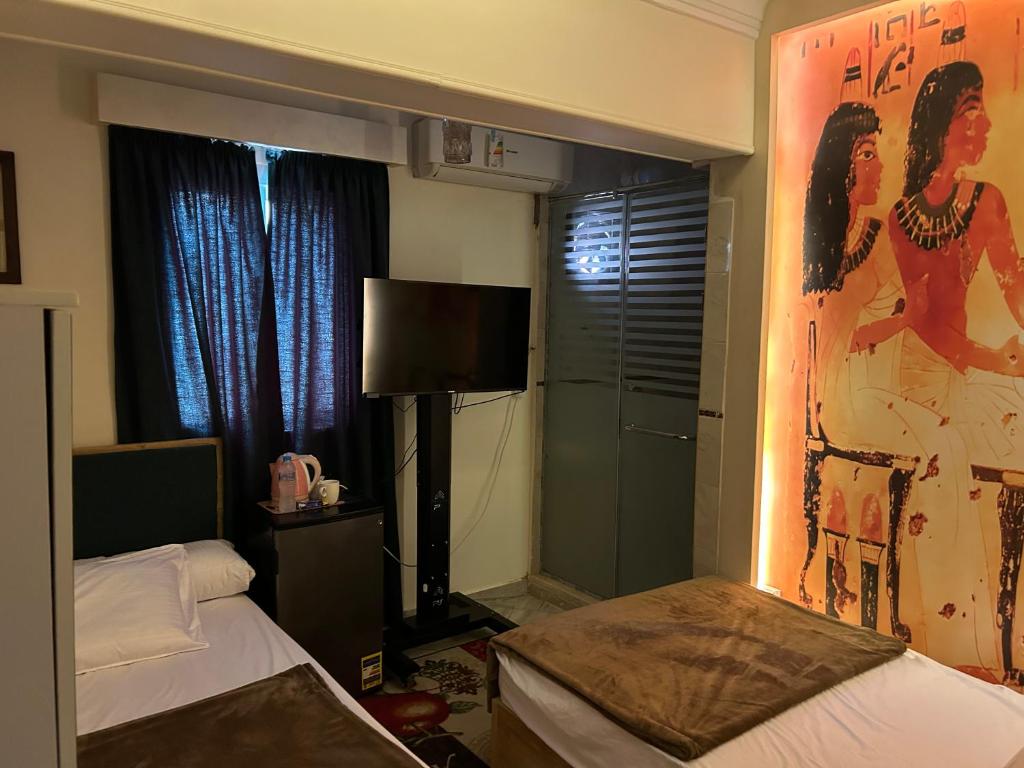 Un pat sau paturi într-o cameră la Matto Pyramids Inn