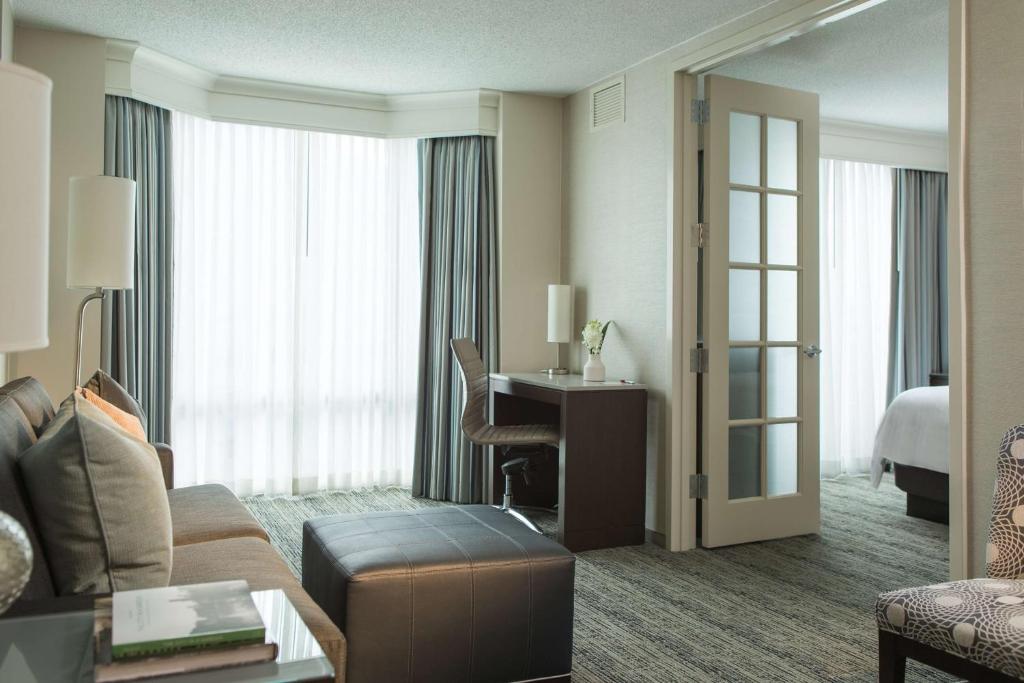 a living room with a couch and a desk in a hotel room at Homewood Suites By Hilton Downers Grove Chicago, Il in Downers Grove