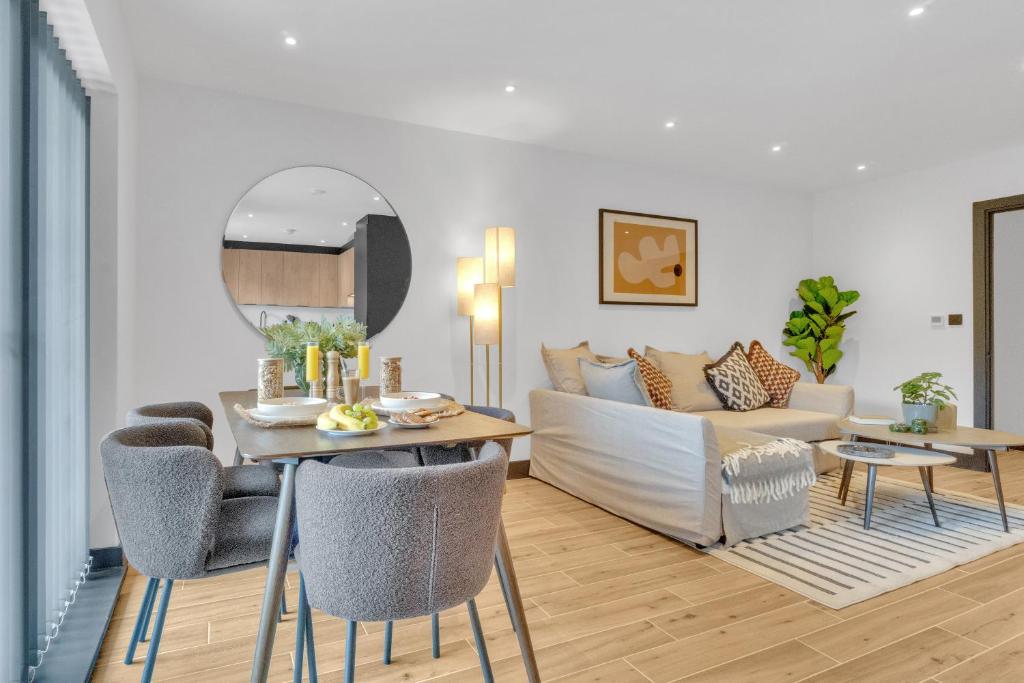 a living room with a table and a couch at homely - North London Luxury Apartments Finchley in Finchley