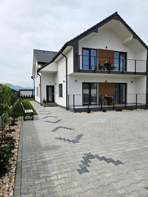 a house with a stone driveway in front of it at Villa Russo in Râşnov