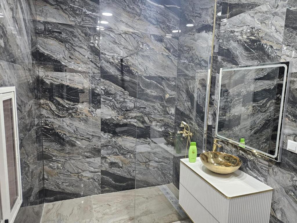a bathroom with a large stone wall at Downtown Apartments in Alicante