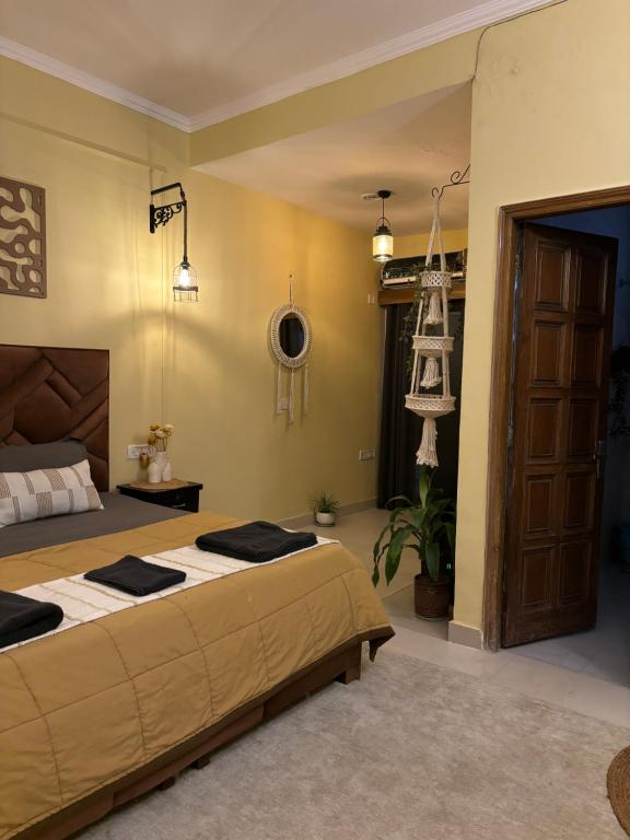 a bedroom with a large bed and a ladder at Atharva's Homestay by Goaround Homes in New Delhi