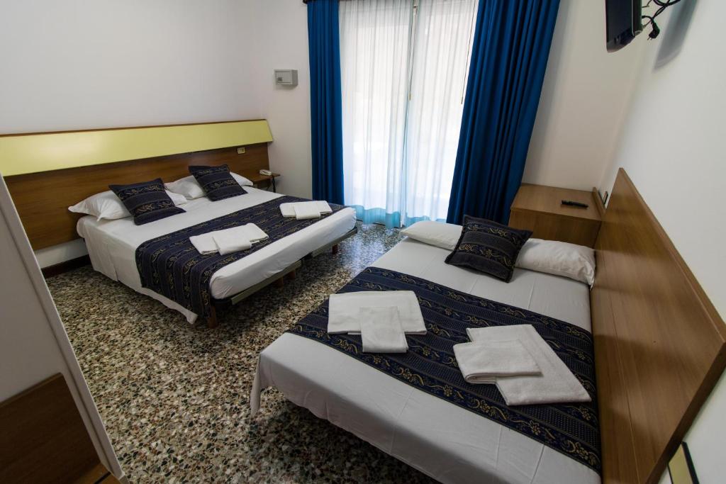 Postel nebo postele na pokoji v ubytování BlueColors Hotel