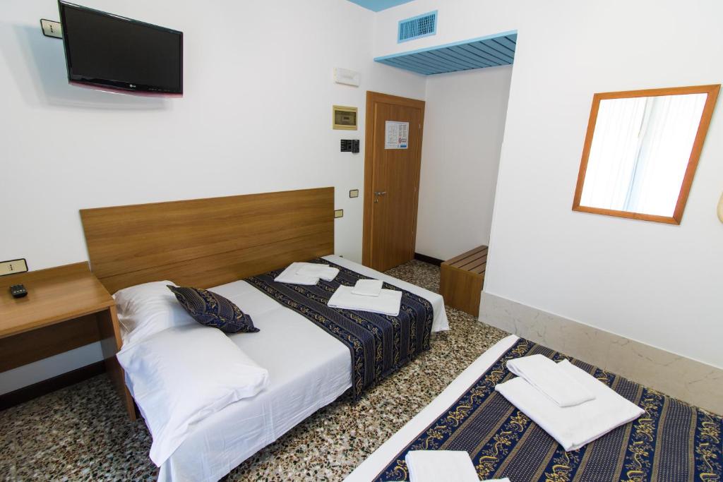 Postel nebo postele na pokoji v ubytování BlueColors Hotel