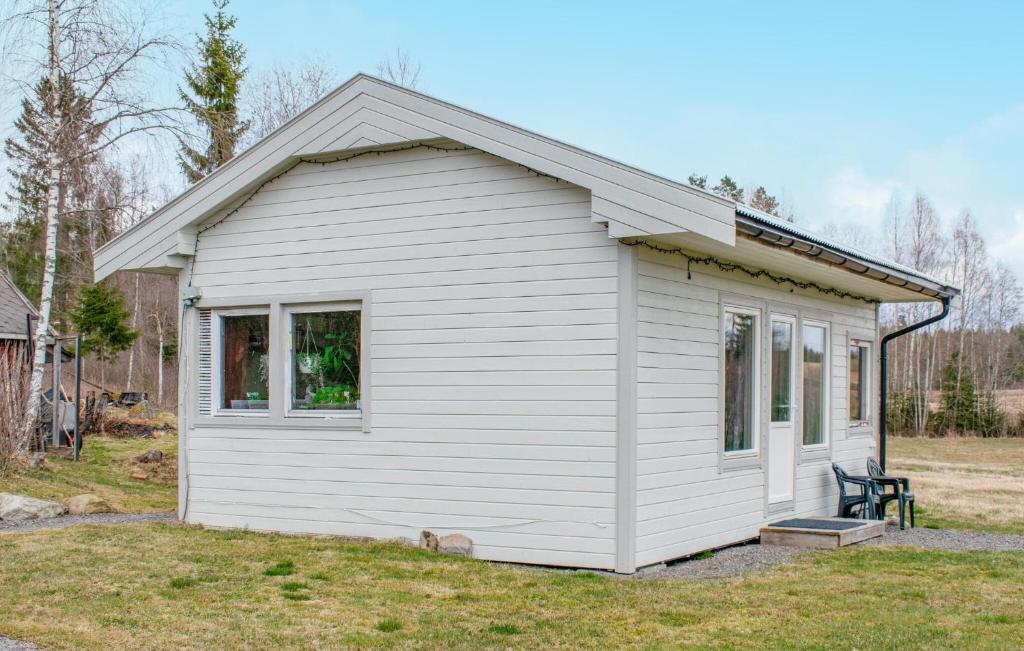 a white tiny house in a yard at 2 Bedroom Stunning Home In Skotterud in Magnor