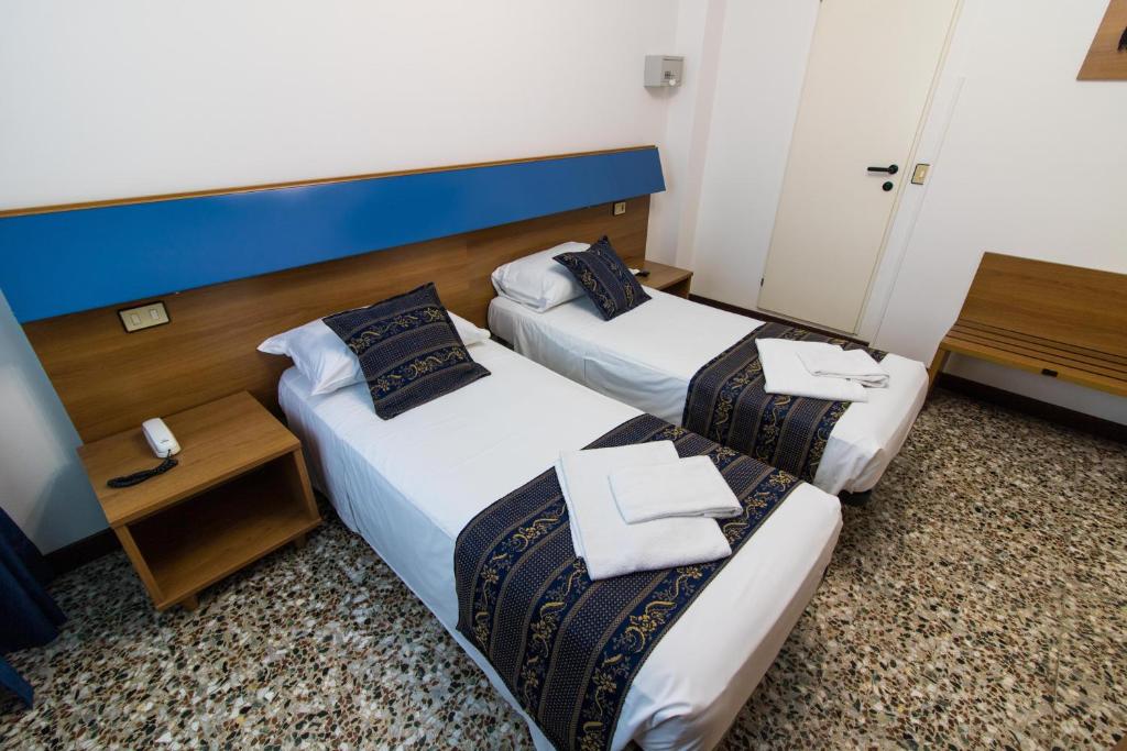 Postel nebo postele na pokoji v ubytování BlueColors Hotel