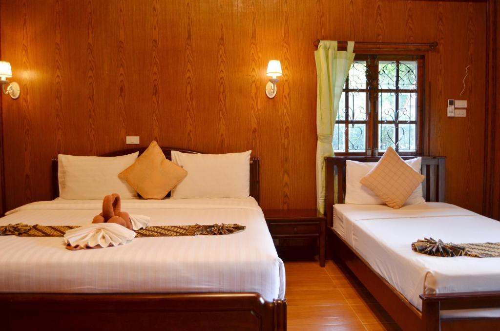 Postel nebo postele na pokoji v ubytování Sayang Beach Resort Koh Lanta