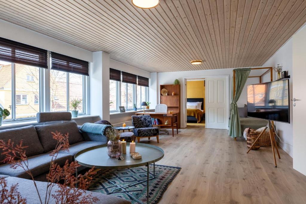 a living room with a couch and a table at Cozy Apartment Stevns in Store Heddinge
