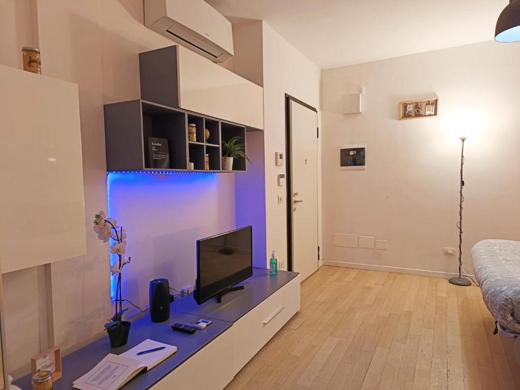 sala de estar con TV y escritorio en YR Apartments Milan - Navigli - Pizza&Pasta Apartment, en Milán