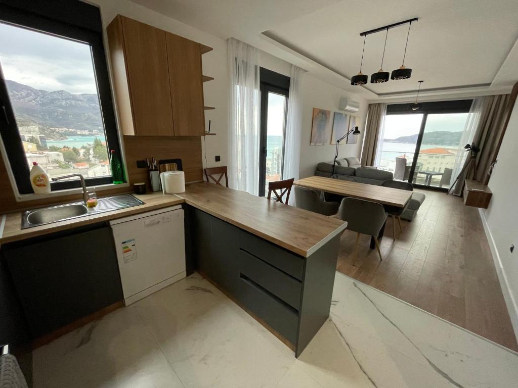 a kitchen and dining room with a view of a table at APARTMENT IVIL - ELIA RESIDENCE in Becici