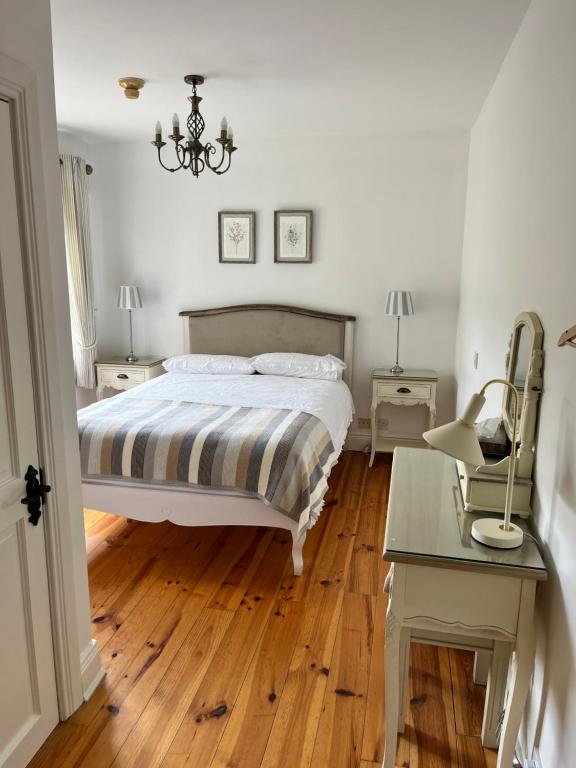 a bedroom with a bed and a table and a chair at The Lodge Donegal Town in Donegal