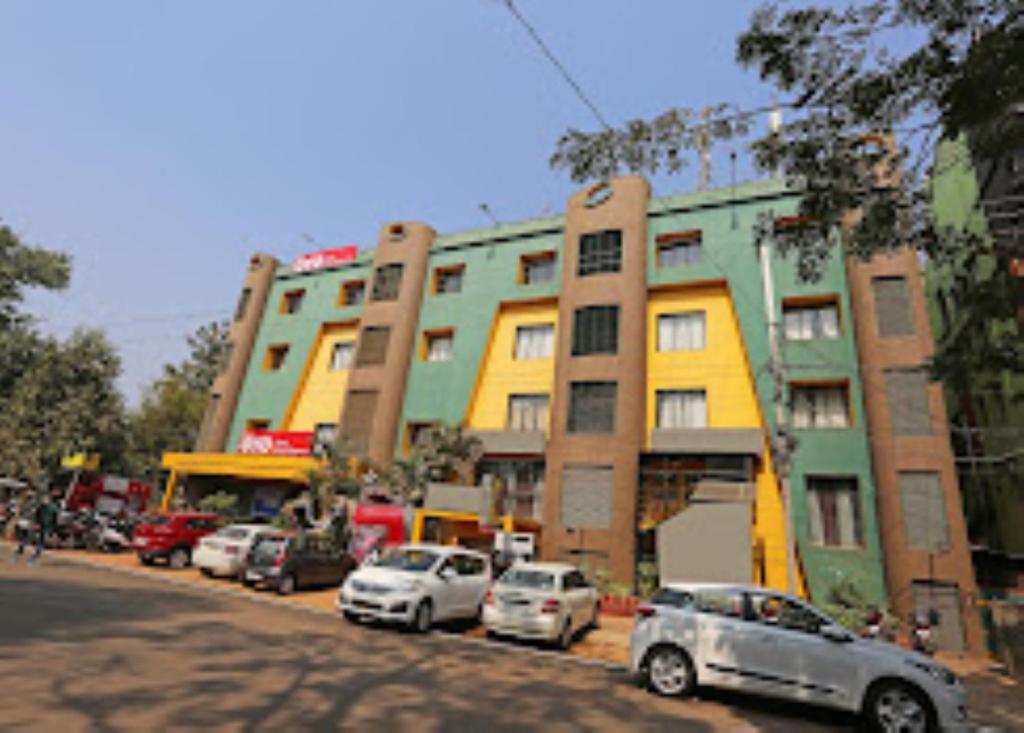a row of cars parked in front of buildings at Hotel Richi Regency Bhubaneswar in Bhubaneshwar