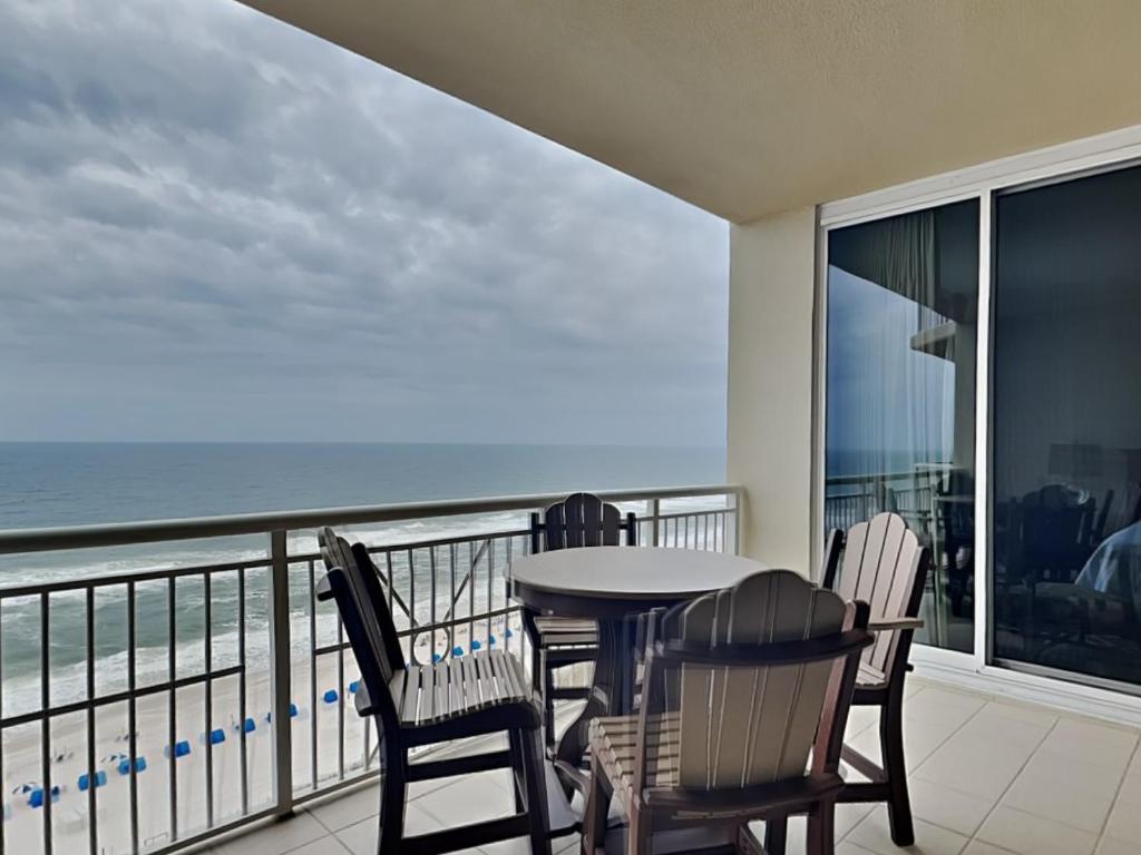 a balcony with a table and chairs and the ocean at Indigo East 1203 in Perdido Key