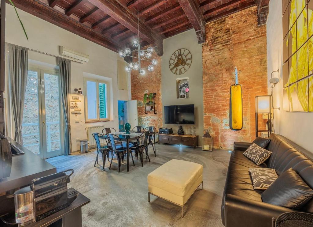 a living room with a couch and a table and chairs at Luxury Apartament Florence in Florence