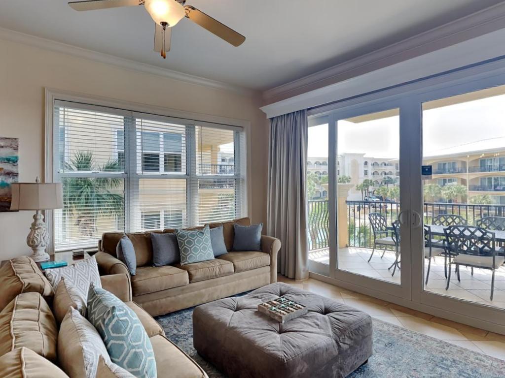 a living room with a couch and a large window at Adagio 301e in Santa Rosa Beach