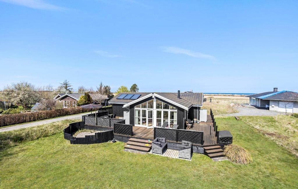 a house with a solarium on a grass field at 3 Bedroom Beautiful Home In Frederikshavn in Frederikshavn