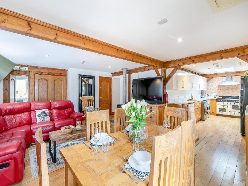 a living room with a red couch and a table at The Lodge in Gloucester