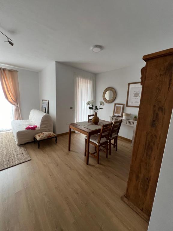 a living room with a table and a couch at Pinares de Boo in Boó de Piélagos
