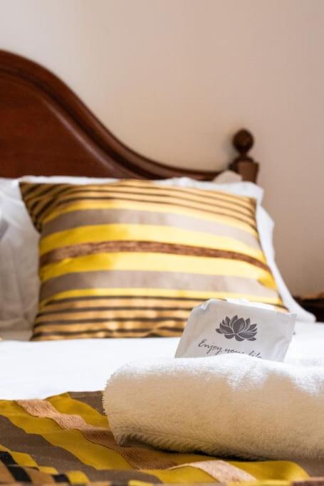a bed with a pillow and a towel on it at Charming Fátima House in Fátima