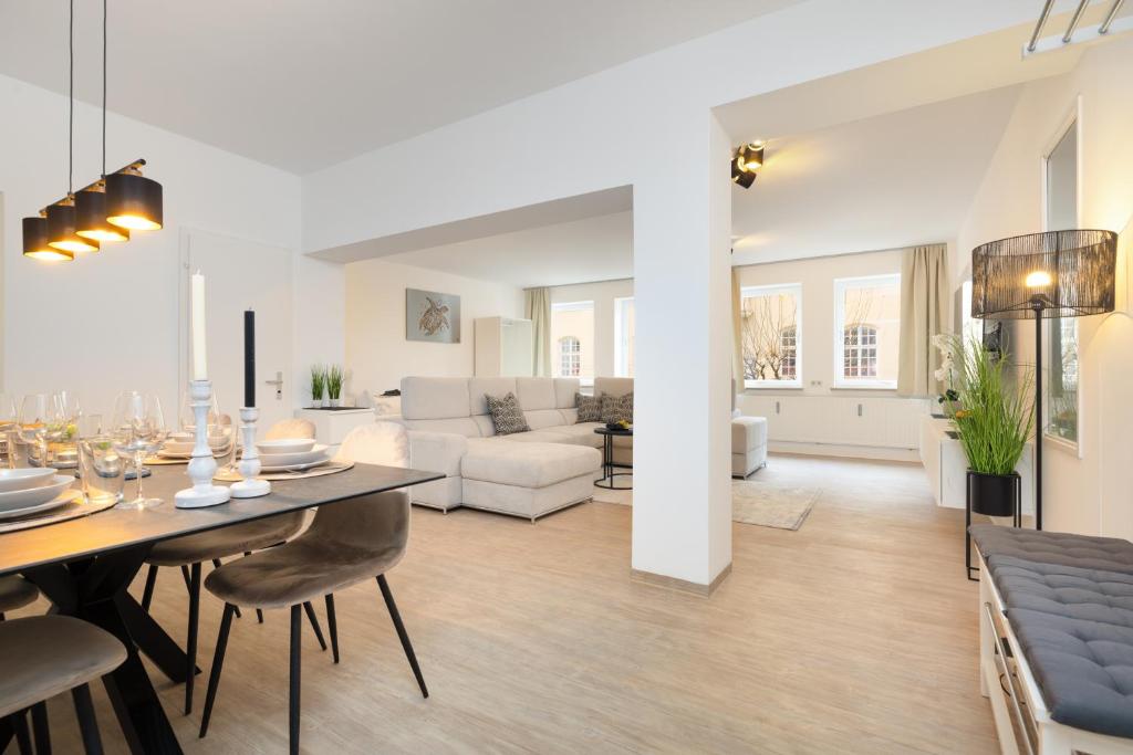 a living room and dining room with a table and chairs at Primero City-Loftdomizil Innenstadt 84qm Netflix in Augsburg