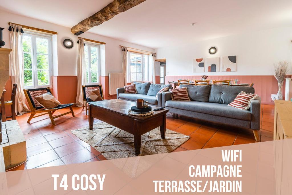 a living room with two couches and a coffee table at LE GRAND FRANC gite cosy proche tous commerces in Tonnay-Charente