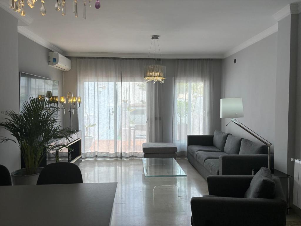 a living room with a couch and a table at Apartamentos Abril in Nerja