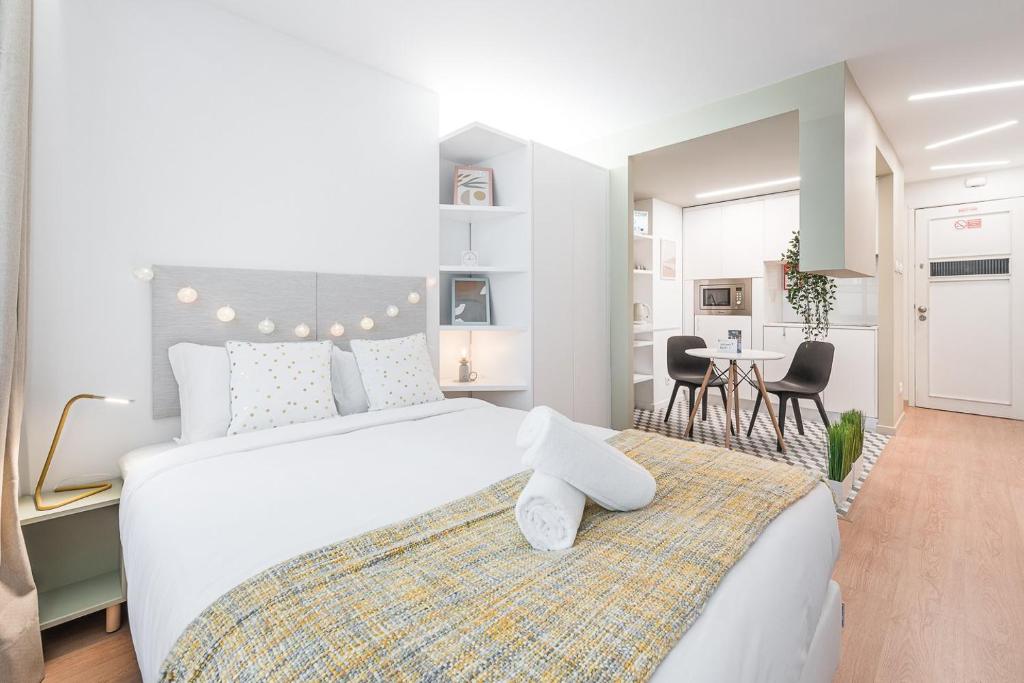 Säng eller sängar i ett rum på GuestReady - Fabric Porto Apartment
