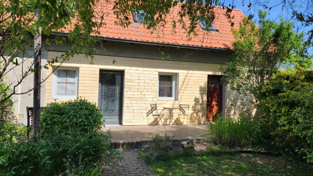 a white house with a table in front of it at Apartmán YASNE in Ostrava