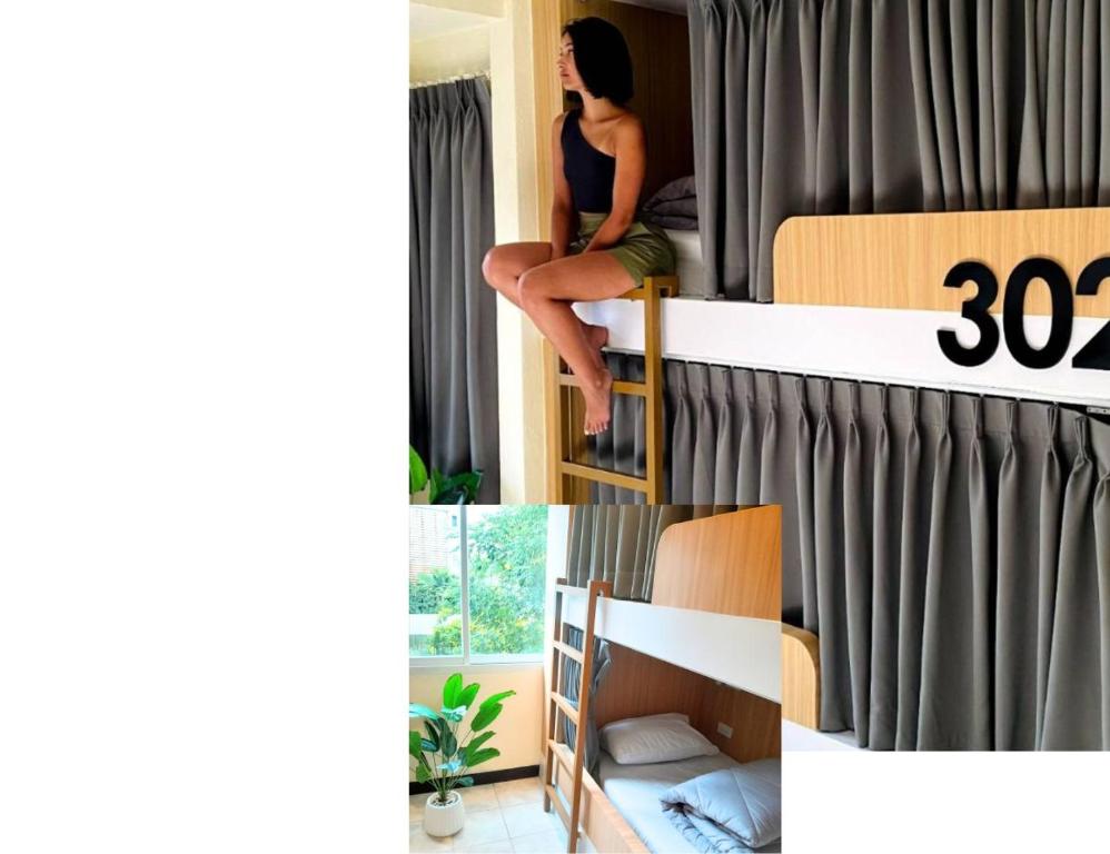 a woman sitting on top of a bunk bed at KPOP Hostel in Karon Beach