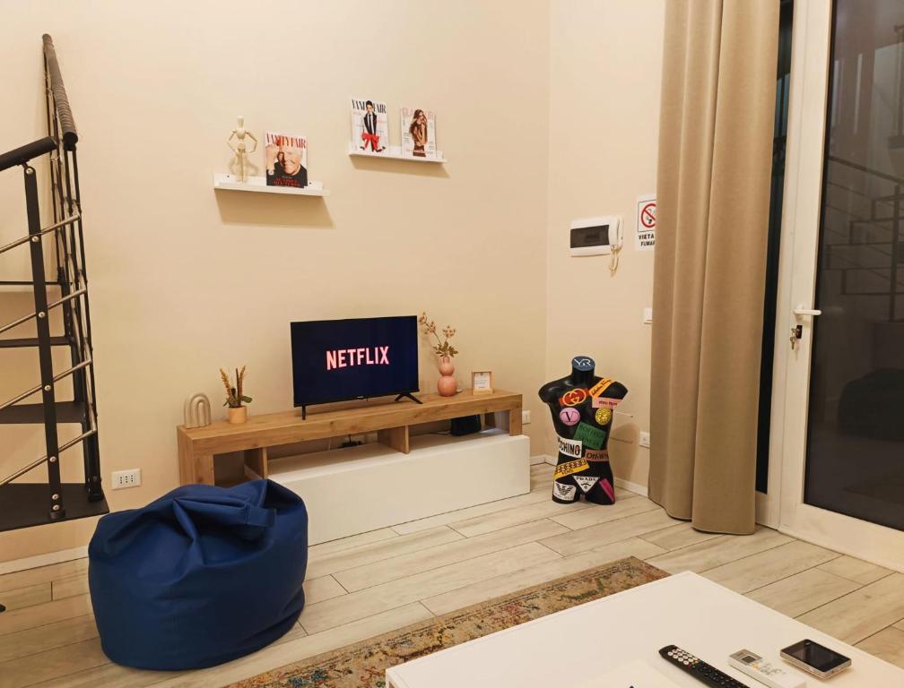 a living room with a television on a table at YR Apartments Milan - Bocconi - Fashion Apartment in Milan