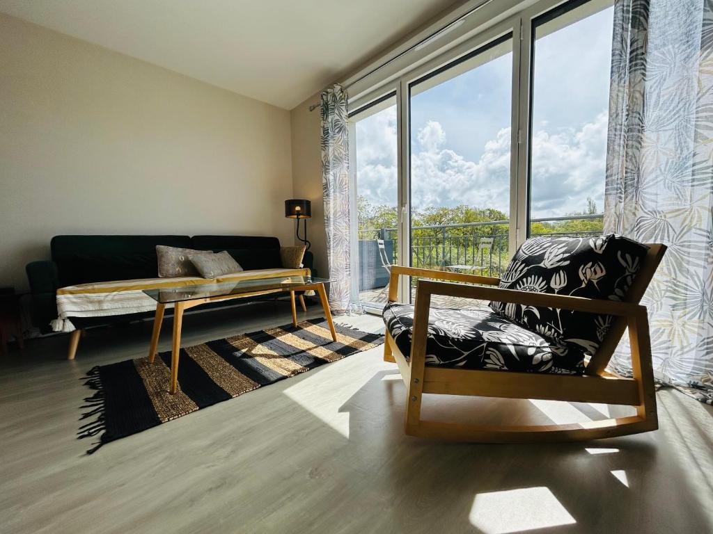 孔卡爾諾的住宿－Appartement plage des sables blancs，带沙发和大窗户的客厅
