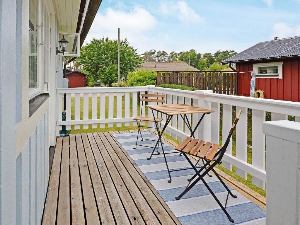 eine Terrasse mit einem Tisch und Stühlen auf einem Haus in der Unterkunft Holiday home LAHOLM XIV in Laholm