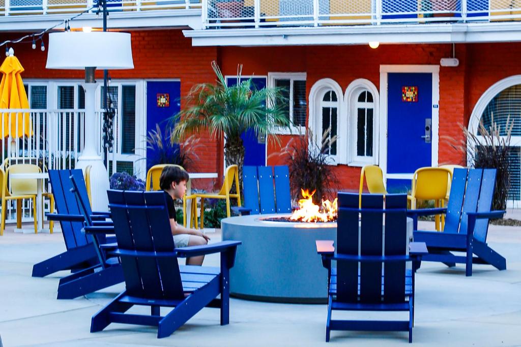 a child sitting in a chair in front of a fire place at Hotel Del Sol in San Francisco