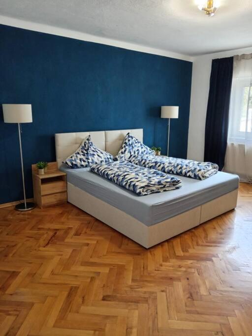 a bedroom with a bed with pillows on it at Ferienwohnung Allgäu 3 in Memmingen