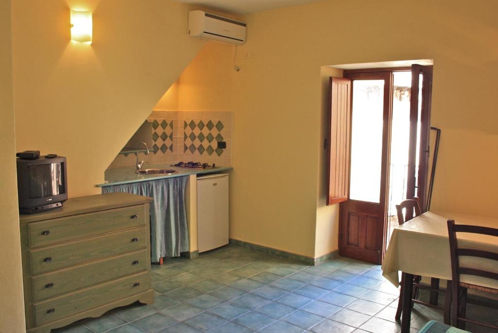 a kitchen with a dresser and a sink at Al 199 in Cefalù